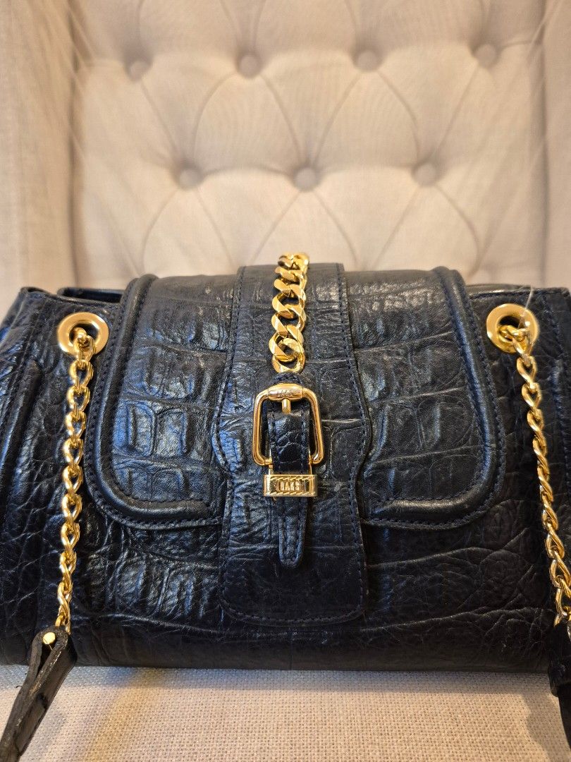 DAKS Croc Leather Bag (Category: Luxury Bags & Wallets) located in Makati City. Submitted by femosseverything (Listing ID 1454318407, Image 2). Description: Dark Blue shoulder bag features a croc-embossed texture and gold chain straps.The design resembles a Balenciaga Crush bag with its structured silhouette and gold hardware. In pristine condition. Not used as much.