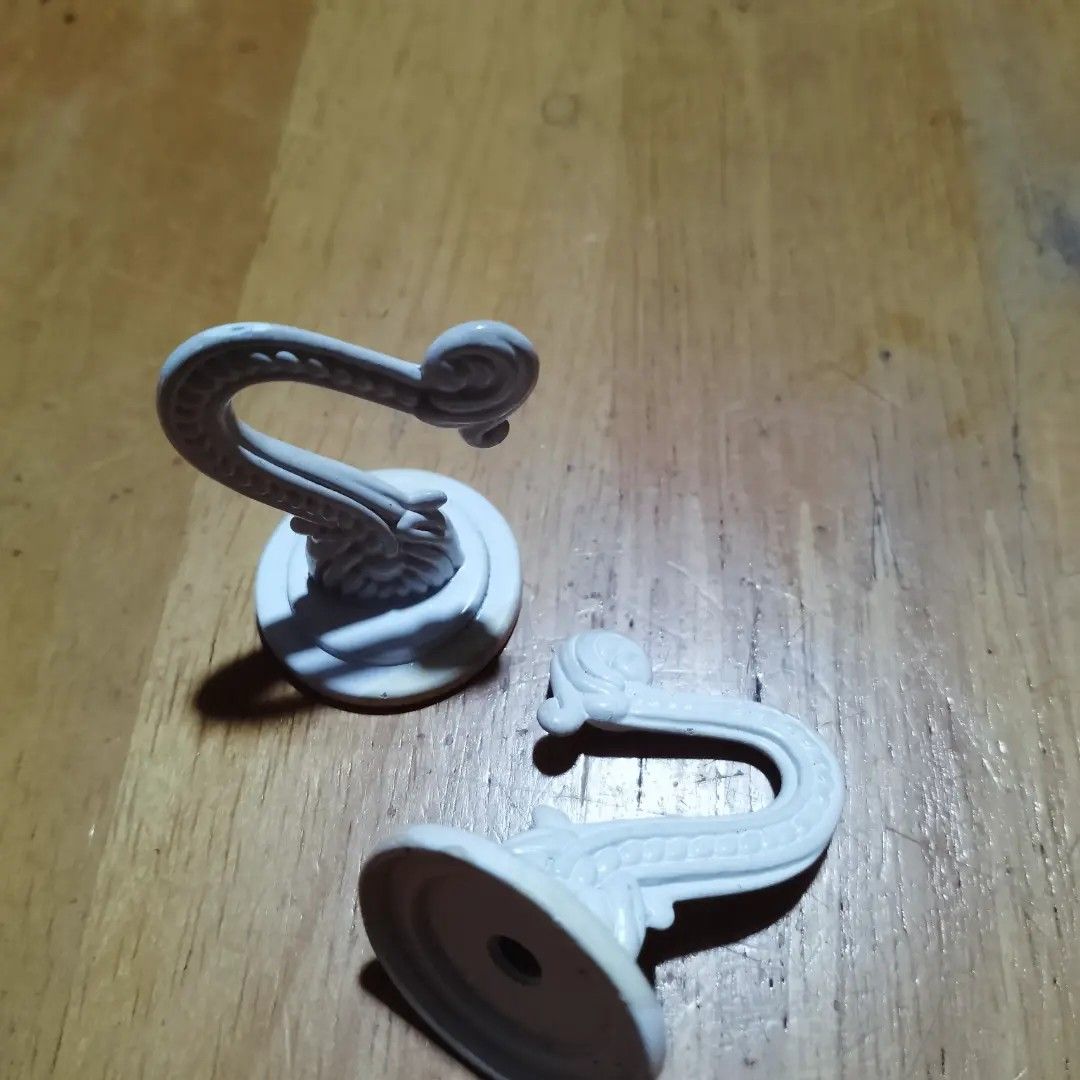 Decorative White Wall Hooks Set of 2 (Category: Wall Decor) located in Baguio. Submitted by klutter.curio (Listing ID 1454244578, Image 1). Description: - Set of 2 white decorative wall hooks - Ornate, vintage-inspired design - Ideal for hanging light items (keys, small bags, jewelry) - Easy to mount - Adds a charming touch to any wall.
