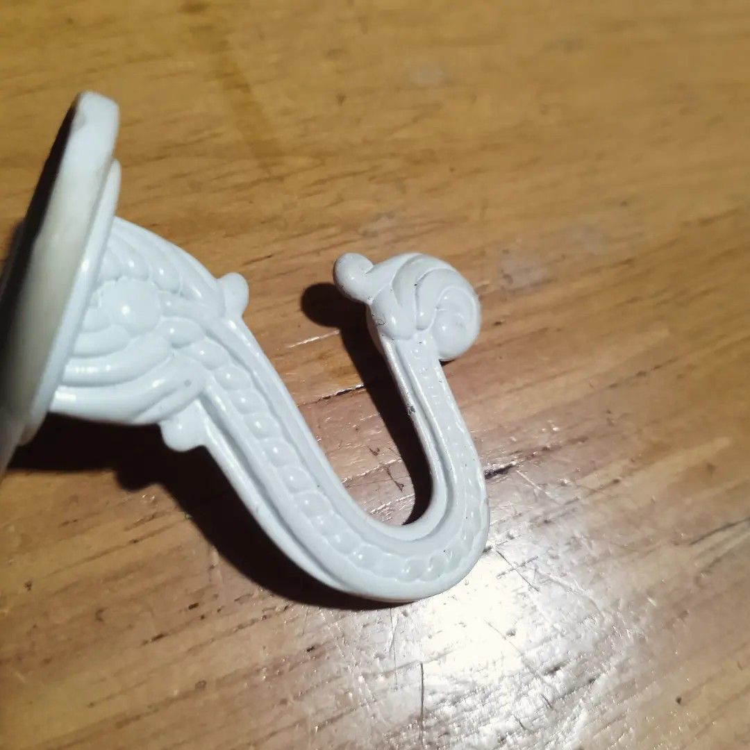 Decorative White Wall Hooks Set of 2 (Category: Wall Decor) located in Baguio. Submitted by klutter.curio (Listing ID 1454244578, Image 2). Description: - Set of 2 white decorative wall hooks - Ornate, vintage-inspired design - Ideal for hanging light items (keys, small bags, jewelry) - Easy to mount - Adds a charming touch to any wall.