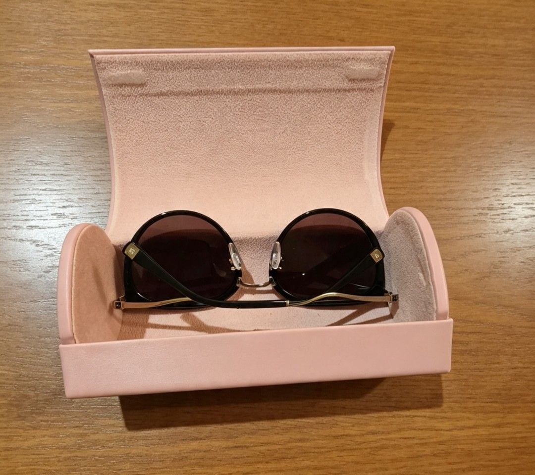 Escada Black Cat-Eye Sunglasses with Case (Category: Sunglasses & Eyewear) located in Naga. Submitted by solamia (Listing ID 1454233065, Image 3). Description: - Chic black cat-eye sunglasses - Elegant gold accents on arms and temples - Comes with a protective pink hard case - Case features a stylish gold logo - Ideal for sunny days - Protect your eyes with fashionable flair.