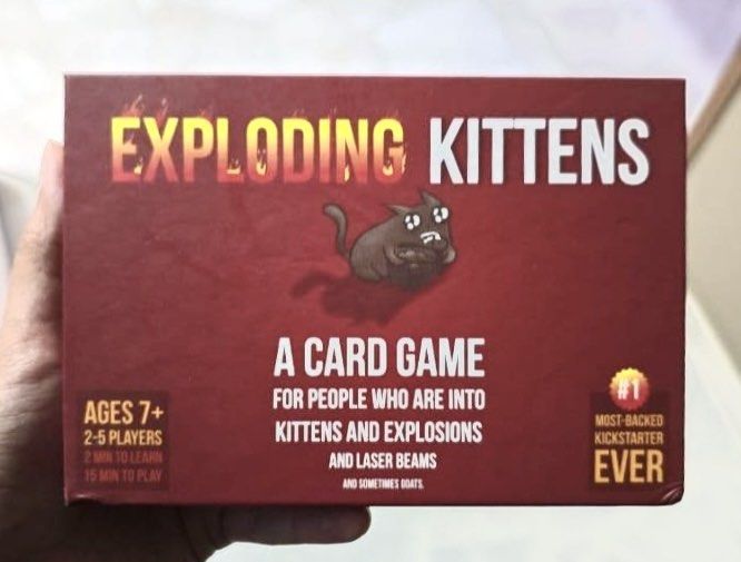 Exploding Kittens with Expansion pack (Category: Board Games & Puzzles) located in Singapore. Submitted by curatedsociety (Listing ID 1454296137, Image 2). Description: Selling my Exploding Kittens card game bundle in 7/10 condition. Includes: * Exploding Kittens (Base Game) * Imploding Kittens Expansion * Barking Kittens Expansion * Recipes for Disaster .