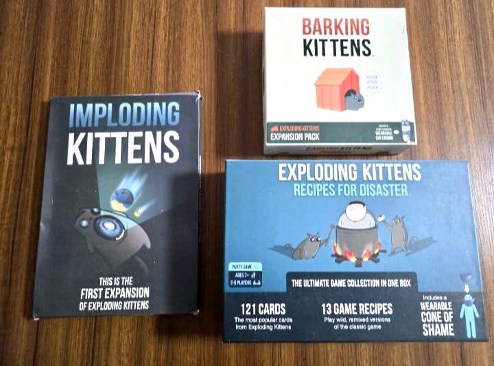 Exploding Kittens with Expansion pack (Category: Board Games & Puzzles) located in Singapore. Submitted by curatedsociety (Listing ID 1454296137, Image 1). Description: Selling my Exploding Kittens card game bundle in 7/10 condition. Includes: * Exploding Kittens (Base Game) * Imploding Kittens Expansion * Barking Kittens Expansion * Recipes for Disaster .