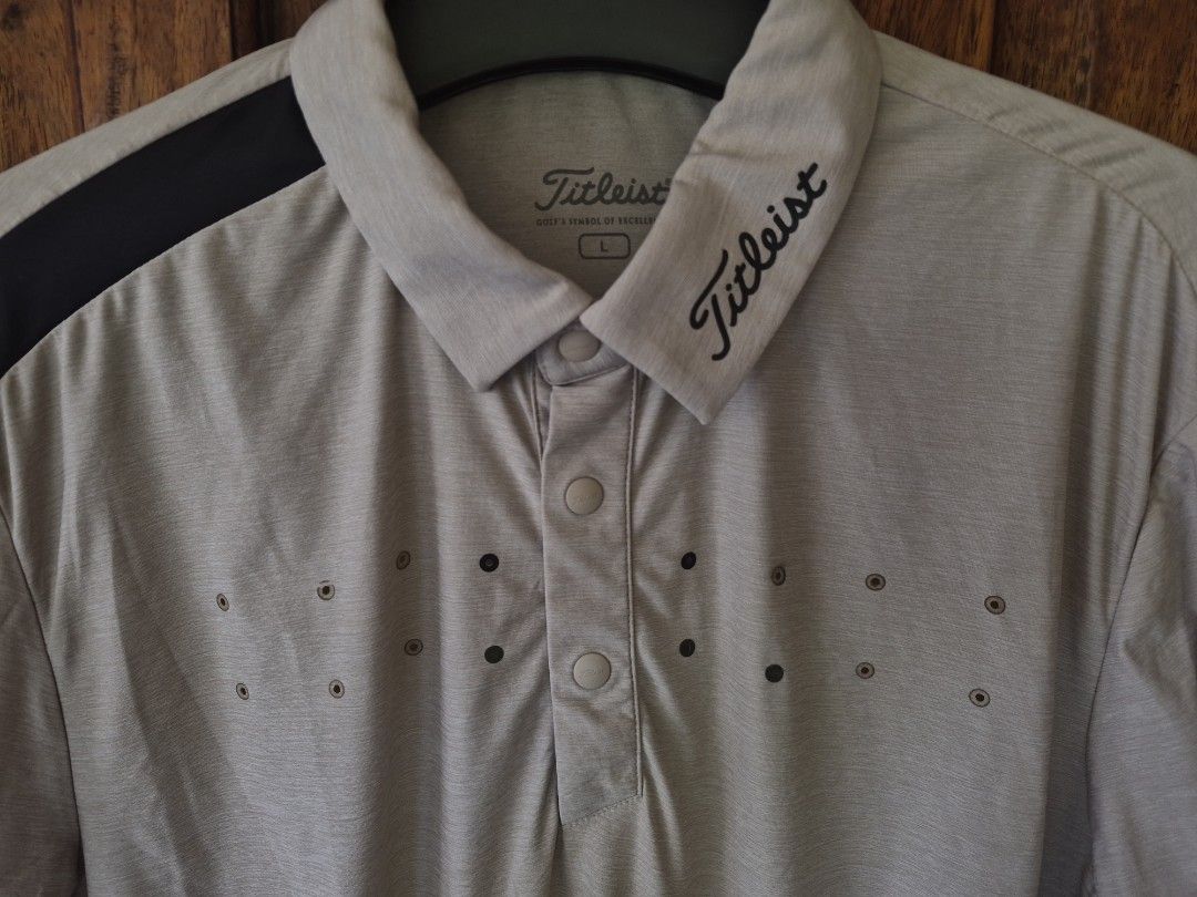 Fitleist Golf Polo Shirt Size L Beige (Category: Tshirts & Polo Shirts ) located in Davao. Submitted by rodrigoani57168 (Listing ID 1454310032, Image 2). Description: - Titleist Golf Polo Shirt - Size: Large (L) - Color: Beige with black shoulder accents - Features Titleist logo on the collar - Made from breathable fabric, ideal for golf - Button placket - Perforated chest area for enhanced ventilation - No issue -Color Rate 10/10 -Dimes: inches 