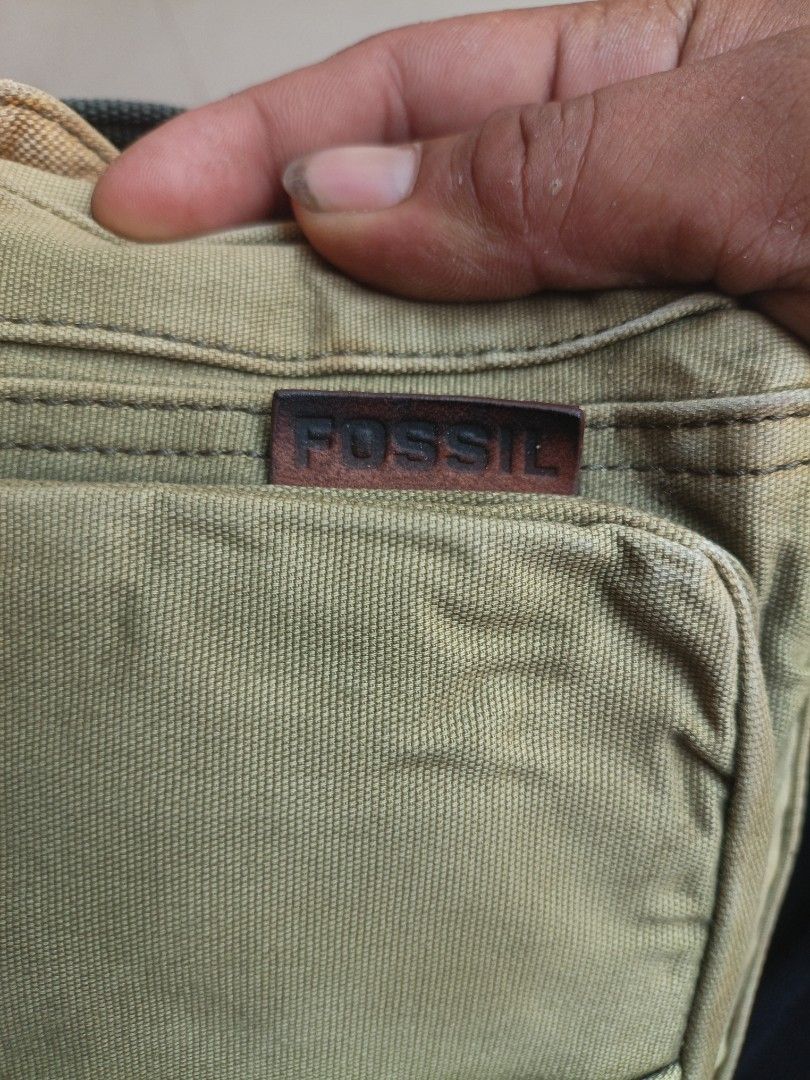 Fossil Brand Canvas Messenger Bag Khaki (Category: Sling Bags) located in Manila. Submitted by treblig. (Listing ID 1454323270, Image 3). Description: - Fossil Khaki Canvas Messenger Bag - Stylish plaid lining inside - Multiple pockets for organized storage - Adjustable strap for comfortable wear - Ideal for everyday use - Please check photos for detailed condition.