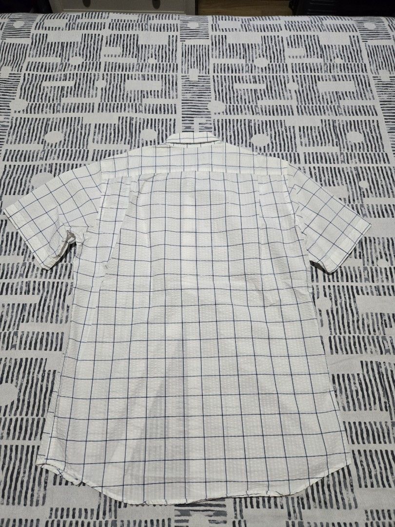 Gap Polo Shirt (Category: Coats, Jackets and Outerwear) located in Quezon City. Submitted by mgdeclutters (Listing ID 1454193268, Image 3). Description: - Brand: Gap - Type: Short Sleeve Polo Shirt - Size: XS (EU 46/UK 36/US 36) - Color: White with blue grid pattern - Condition: Good, pre-loved - Style: Casual, classic.