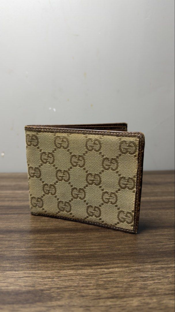 Gucci GG Monogram Canvas Bi-fold Wallet (Category: Luxury Bags & Wallets) located in Baguio. Submitted by fndrskprskid (Listing ID 1454348930, Image 1). Description: - Authentic Gucci wallet - Classic GG monogram canvas - Brown leather trim and interior - Bi-fold design with card slots and compartments - Timeless accessory.