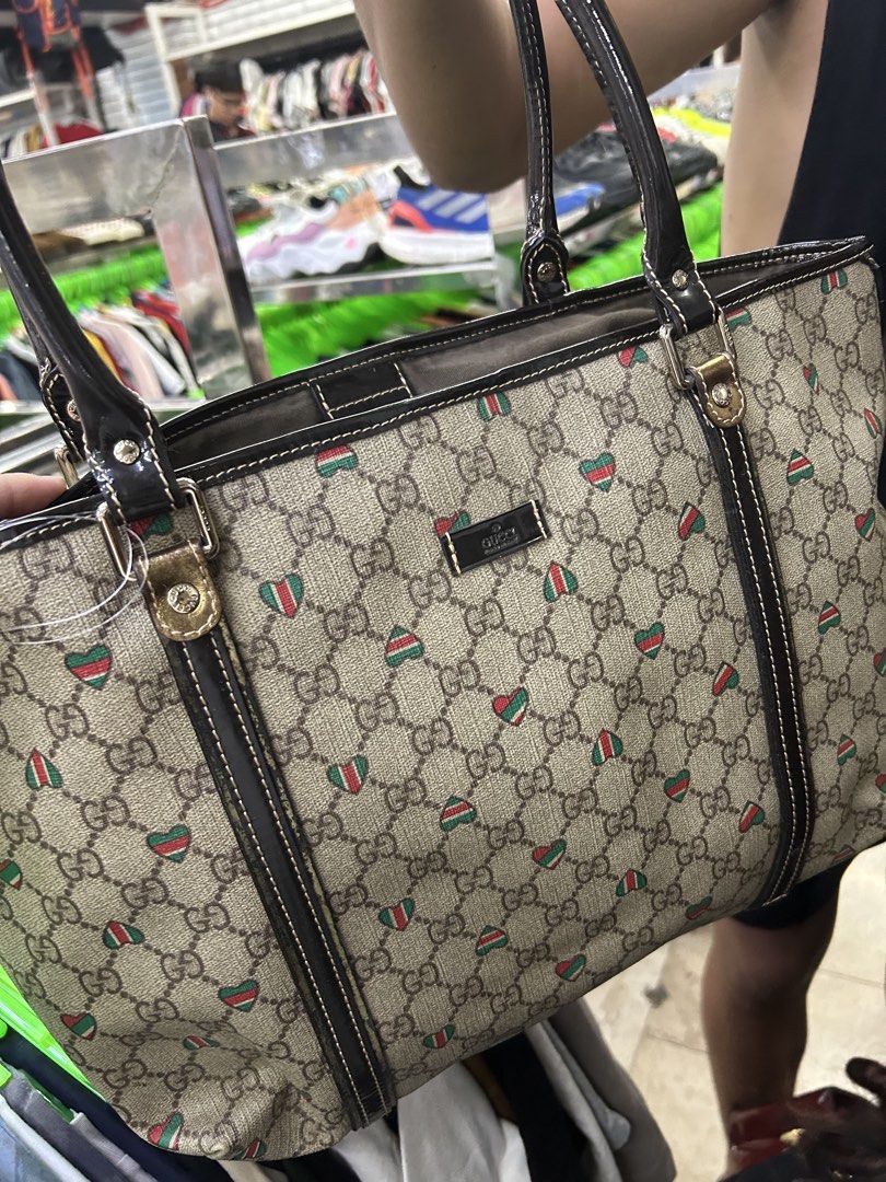 Gucci Monogram Heart Tote Bag (Category: Luxury Bags & Wallets) located in Caloocan City. Submitted by coolwhale-76ba (Listing ID 1454336083, Image 1). Description: - Gucci tote bag - Classic GG monogram with red and green heart accents - Patent leather trim and handles - Interior zip pocket - Serial number visible in photos - Perfect everyday bag.
