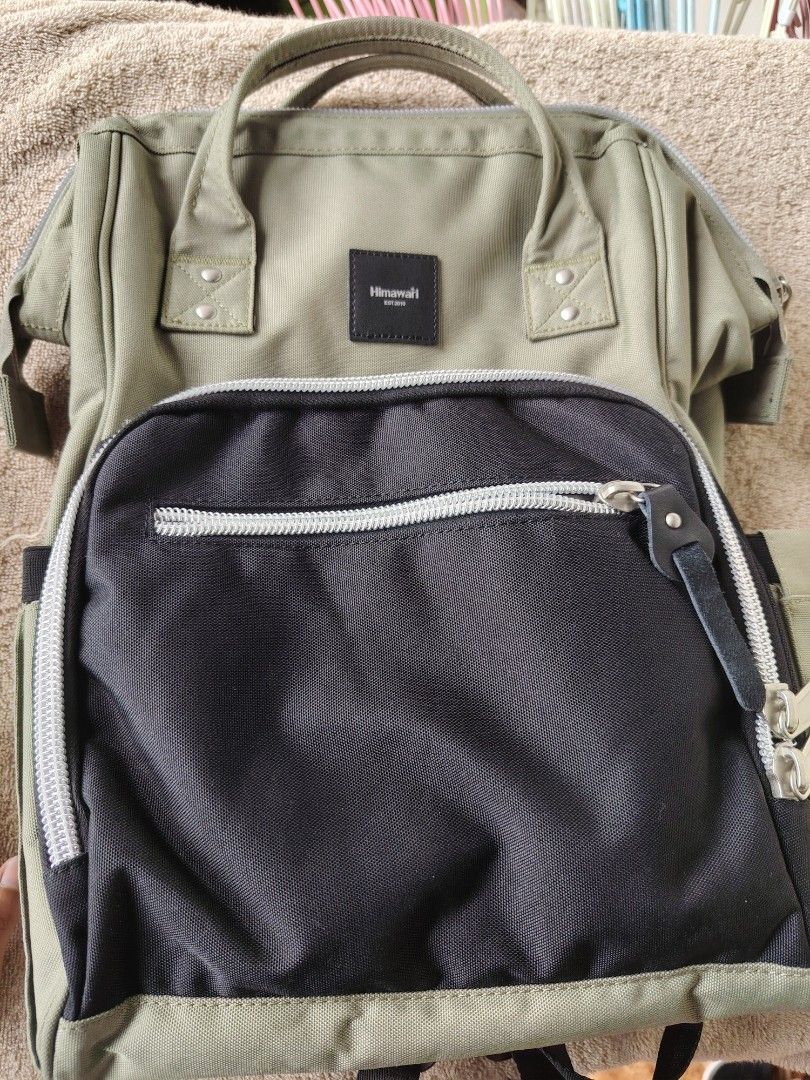 Himawari Diaper Backpack - Khaki Green (Category: Backpacks) located in General Trias. Submitted by ryltecson (Listing ID 1454304010, Image 1). Description: - Khaki green Himawari Diaper backpack - Size 17*14*4 inches - Black front pocket with zipper - Multiple compartments inside for organization - Adjustable straps - Ideal for everyday use or travel with toddler - used twice only - with Free large sling bag .
