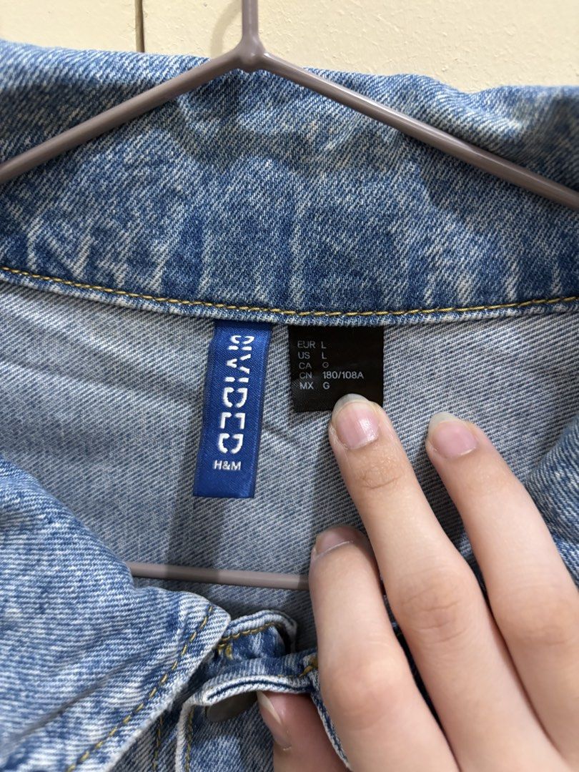 H&M Divided Unisex Light-Washed Distressed Denim Jacket (Category: Coats, Jackets and Outerwear) located in Manila. Submitted by abuyforyou (Listing ID 1454283652, Image 3). Description: Worn a few times 10/10 condition L - 26 1.25" W - 23 1.25".