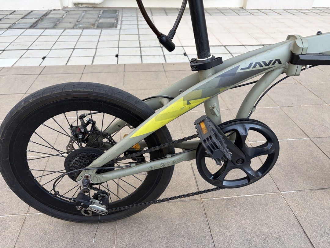 Java Folding Bike (Category: Bicycles) located in Singapore. Submitted by carlaleigh777 (Listing ID 1454281397, Image 3). Description: Selling my well-used Java folding bike. Specs: * 20” wheels * Shimano 9-speed * Mechanical disc brakes * Alloy frame * Foldable design Condition: * Normal wear and tear consistent with use * Cassette needs cleaning * Some surface rust on a bolts * Right brake is weaker and may need adjustment or servicing Selling 