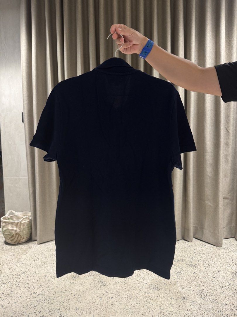 Lacoste Navy Blue Polo Shirt with Patch (Category: Tshirts & Polo Shirts ) located in Manila. Submitted by rb.declutters (Listing ID 1454338696, Image 2). Description: - Classic navy blue Lacoste polo shirt - Features iconic crocodile logo patch on chest - Short sleeves - Button-up collar - Versatile for casual or smart-casual wear - Pairs well with jeans or shorts.