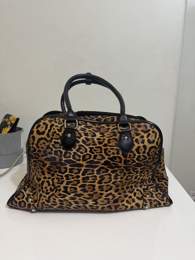 Leopard Print 'Spoiled Made' Duffle Bag (Category: Luxury Bags & Wallets) located in Quezon City. Submitted by loveangelmusicbaby (Listing ID 1454306436, Image 3). Description: -bought this in Vietnam -Width 18 inches x Height 11 inches - Adorable leopard print duffle bag - Stylish black handles and trim - Ideal for weekend getaways or everyday use - A unique and eye-catching statement piece.