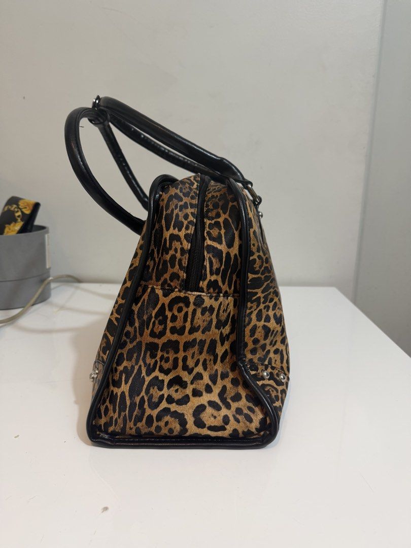 Leopard Print 'Spoiled Made' Duffle Bag (Category: Luxury Bags & Wallets) located in Quezon City. Submitted by loveangelmusicbaby (Listing ID 1454306436, Image 2). Description: -bought this in Vietnam -Width 18 inches x Height 11 inches - Adorable leopard print duffle bag - Stylish black handles and trim - Ideal for weekend getaways or everyday use - A unique and eye-catching statement piece.