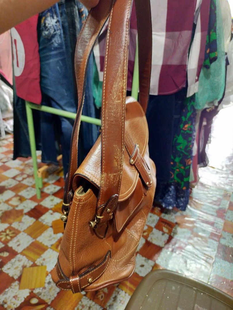 Liz Genuine Leather bag 💯% original (Category: Shoulder Bags) located in Manila. Submitted by new-opening (Listing ID 1454241780, Image 3). Description: Brown leather shoulder bag from LC. Has the LC logo and 'est. 1976 LEATHER' stamped inside. The leather has a nice texture. The strap is adjustable with buckles. Some signs of wear on the strap and edges, but still a solid bag. Plenty of space inside..