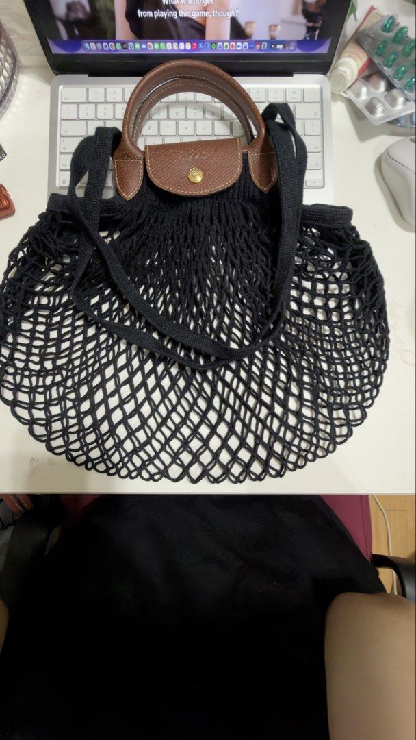 Longchamp Filet Bag Large (Category: Luxury Bags & Wallets) located in Quezon City. Submitted by cherry081072 (Listing ID 1454242802, Image 2). Description: - Classic black net tote bag - Features brown leather handles and trim - Iconic Longchamp snap closure - Ideal for groceries or everyday use - Lightweight and easy to use - Rarely used - Bought in SOHO Longchamp store in New York - Original - SRP 130$ plus tax -negotiable.