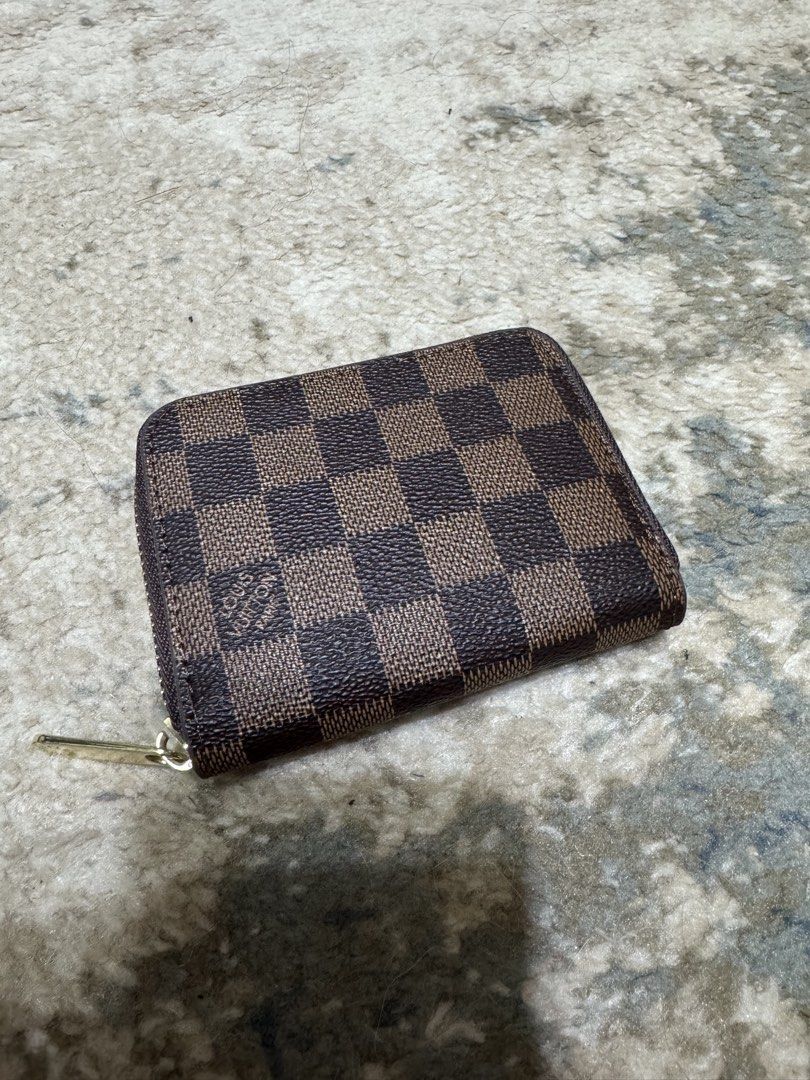Louis Vuitton Damier Ebene Coin Purse (Category: Luxury Bags & Wallets) located in Manila. Submitted by milleshoppppp (Listing ID 1454306441, Image 1). Description: - Secure zipper closure - Interior features card slots and a main compartment - Never been used.