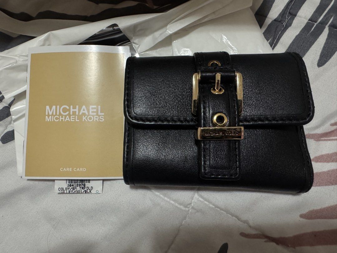 Michael Kors Black Leather Tri-Fold Wallet with Gold Hardware (Category: Wallets & Card holders) located in Pasig City. Submitted by cmmp015 (Listing ID 1454310565, Image 2). Description: Selling my preloved MK Trifold Wallet very good condition complete inclusion Kapitolyo Pasig Location.