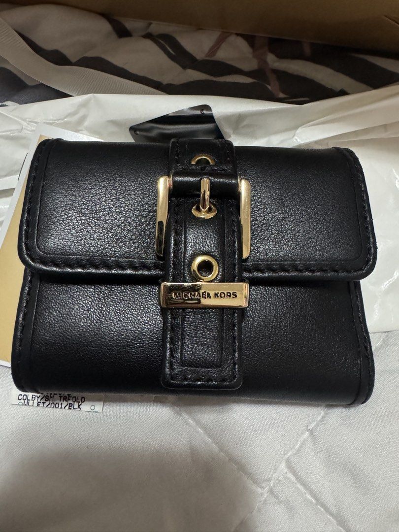 Michael Kors Black Leather Tri-Fold Wallet with Gold Hardware (Category: Wallets & Card holders) located in Pasig City. Submitted by cmmp015 (Listing ID 1454310565, Image 1). Description: Selling my preloved MK Trifold Wallet very good condition complete inclusion Kapitolyo Pasig Location.