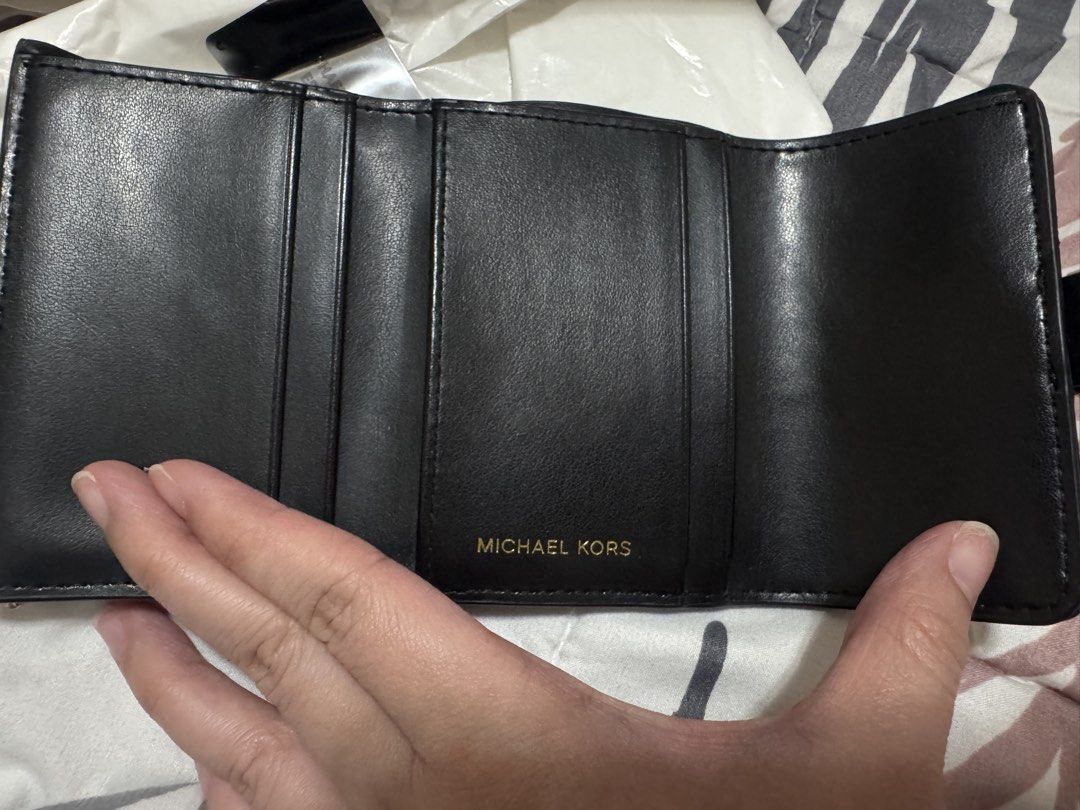 Michael Kors Black Leather Tri-Fold Wallet with Gold Hardware (Category: Wallets & Card holders) located in Pasig City. Submitted by cmmp015 (Listing ID 1454310565, Image 3). Description: Selling my preloved MK Trifold Wallet very good condition complete inclusion Kapitolyo Pasig Location.