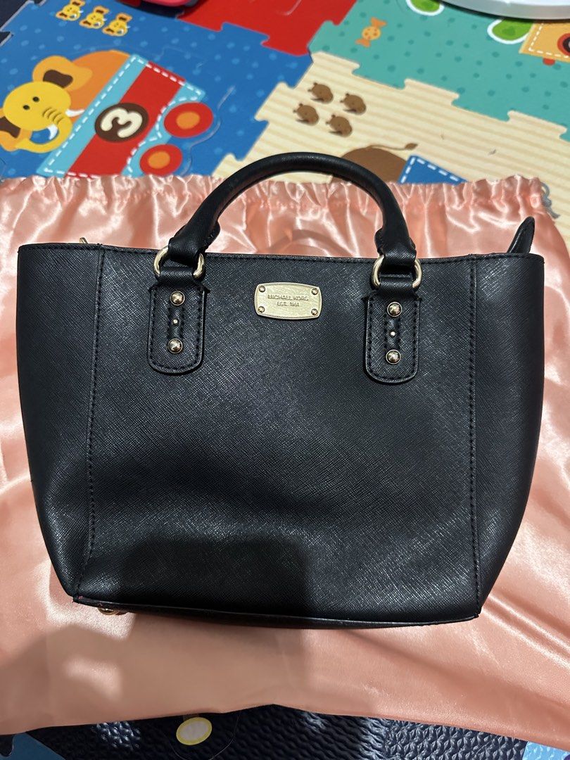 Michael Kors Black Saffiano Leather Bag (Category: Luxury Bags & Wallets) located in Santa Rosa. Submitted by babicdln (Listing ID 1454230720, Image 2). Description: - Authentic Michael Kors Black Saffiano Leather Bag - Slightly used - with Sling .