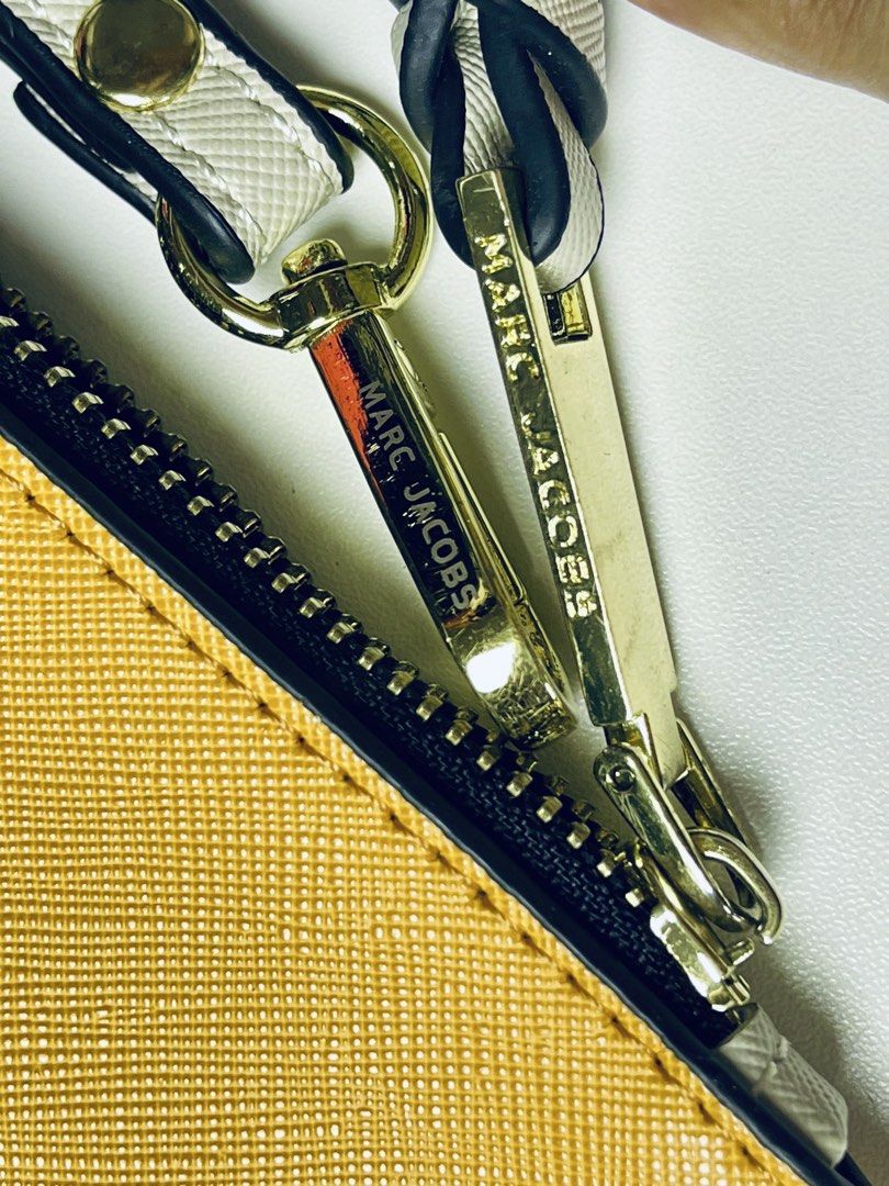 MJ Snapshot Wristlet (Slightly Negotiable) (Category: Purses & Pouches) located in Imus. Submitted by cheratedfinds (Listing ID 1454361095, Image 2). Description: Vibrant yellow and coral pink Saffiano-style flat wristlet with gold-tone hardware! Perfect for quick errands, coffee runs, or organizing your essentials inside a bigger bag. 📌 ITEM DETAILS: • Color: Mustard Yellow / Coral Pink / Cream Strap • Material: Saffiano-style leather finish • 