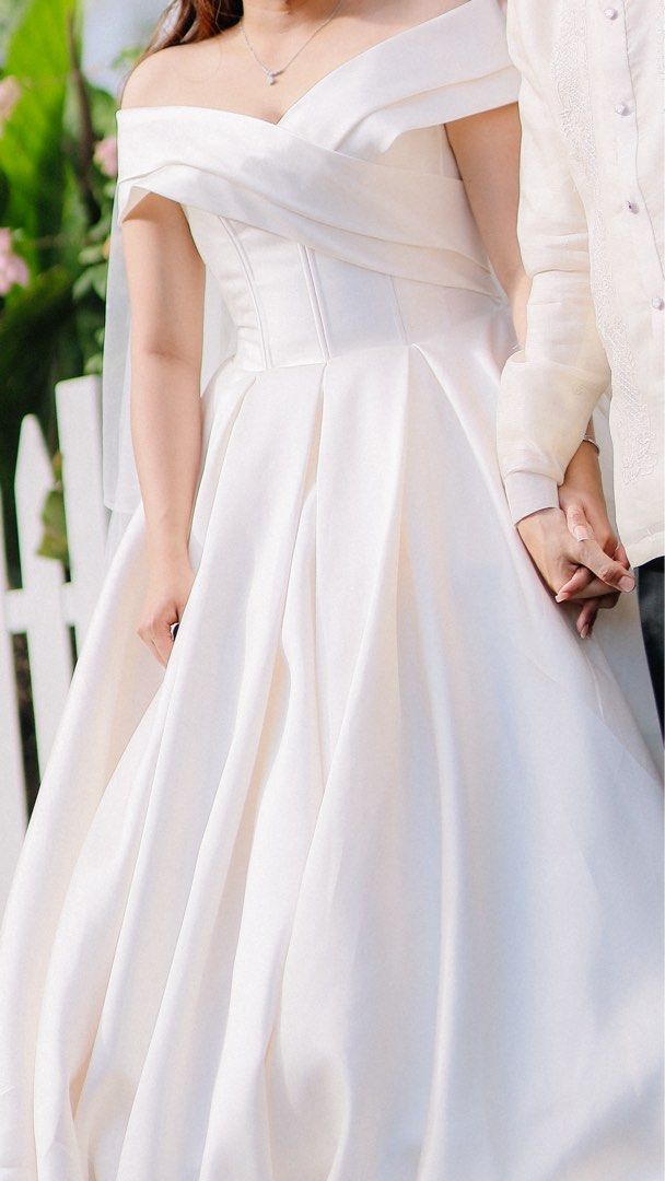 Off-Shoulder Satin Wedding Dress with Veil (Category: Announcements) located in Mandaluyong City. Submitted by mkaba (Listing ID 1454312110, Image 2). Description: - Beautiful off-shoulder wedding gown - Made of luxurious satin fabric - Features a full skirt and elegant train - Comes with a matching veil - Comfortable for dancing and celebrating - Designed to make you feel like a princess.