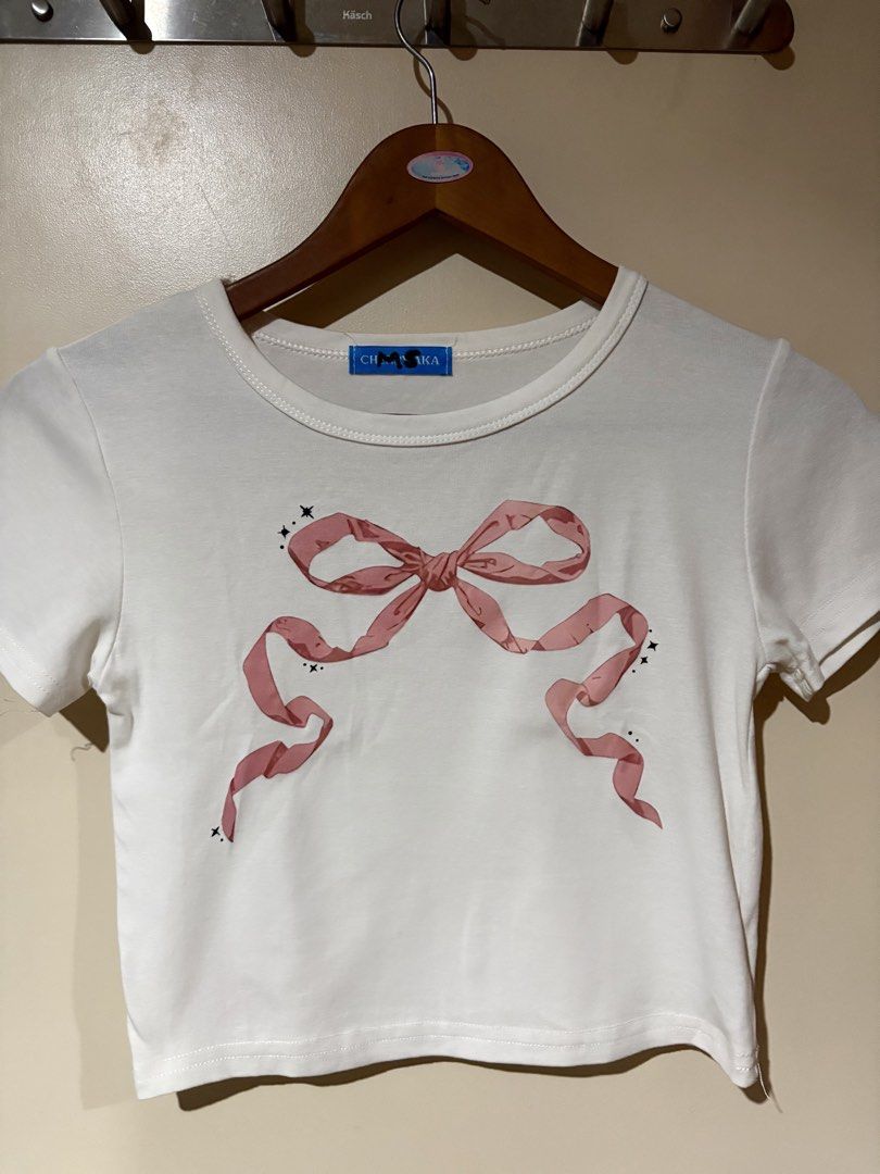 Pink Bow Coquette Cropped Shirt (Category: Shirts) located in Pasig City. Submitted by kitcatss (Listing ID 1454350063, Image 1). Description: 🎀 PINK BOW CROPPED SHIRT 🎀 Orig Price: Php 300 (bought from 🍊app) Size: Small (best fits on size xs or s) *good condition/ initials written on tag Mop: gcash/ paymaya Mod: j&t/ lalamove (sf shoulder by buyer) Rfs: Impulsive buy (worn only 4x) .
