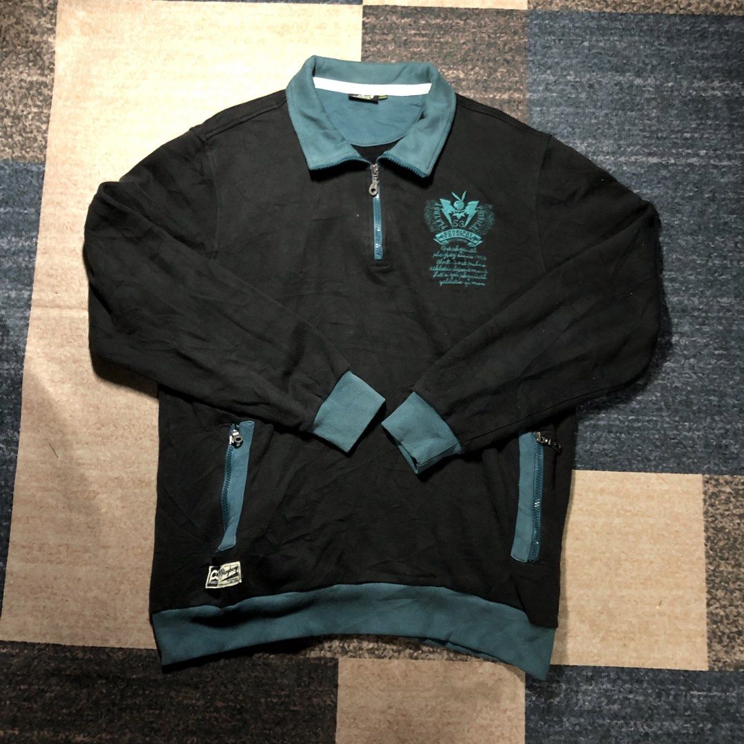 Playboy Physical Black & Teal Zip-Up Sweatshirt (Category: Coats, Jackets and Outerwear) located in Dasmarinas. Submitted by johnlloydm99208 (Listing ID 1454290627, Image 1). Description: - Brand: Playboy Physical - Color: Black with Teal accents (collar, cuffs, waistband) - Style: Long-sleeve sweatshirt - Closure: Half-zip with Playboy bunny zipper pull - Pockets: Two zippered front pockets - Design: Graphic print on the chest - Size: XL - Condi