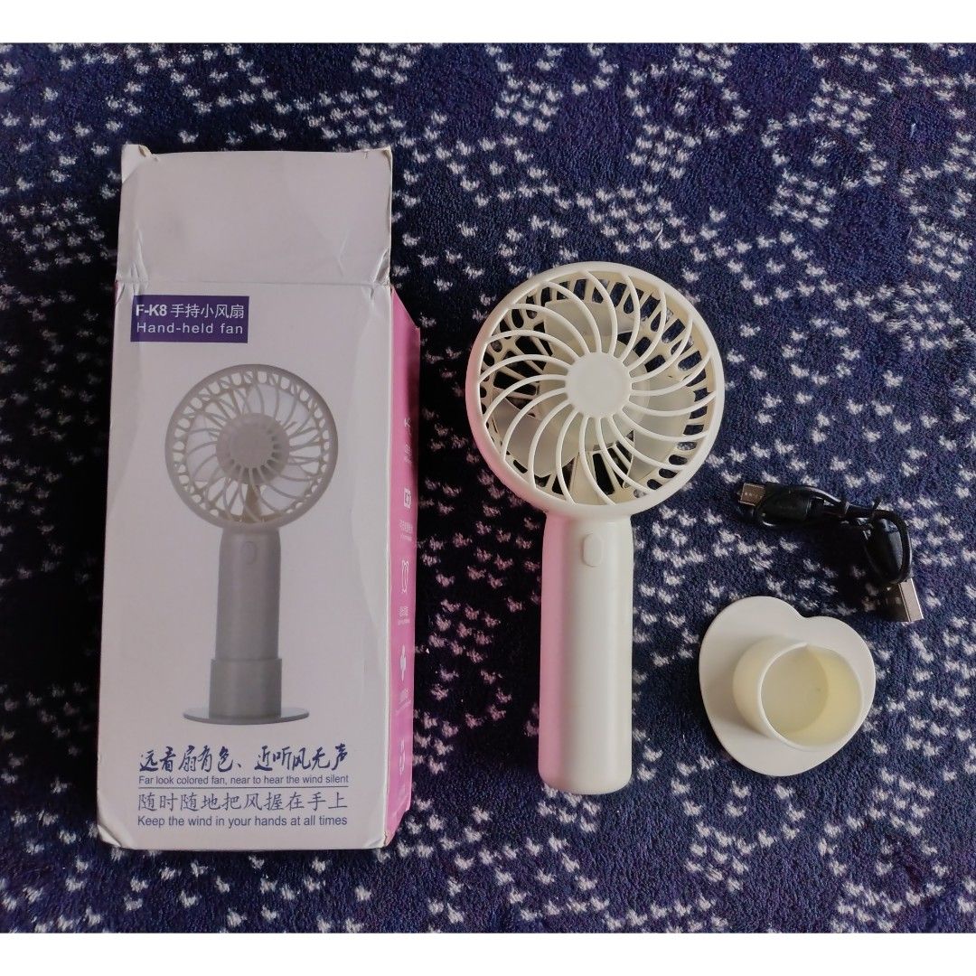 Portable Rechargeable Handheld Fan (Category: Fans) located in Quezon City. Submitted by all_items_50_each (Listing ID 1454285885, Image 1). Description: F-K8 Handheld Fan 3 speed With stand, micro cable 50/each Pink - 5 PCs available White - 5 PCs available *box is crumpled/damaged (due to shipping) *micro cable - not tried/tested 💲ALL ITEMS 50 each 💰MOP: GCash ➕Add shipping fee ❌NO rush shipping, meet up, haggling ✔️for rush, use grab/lalamov