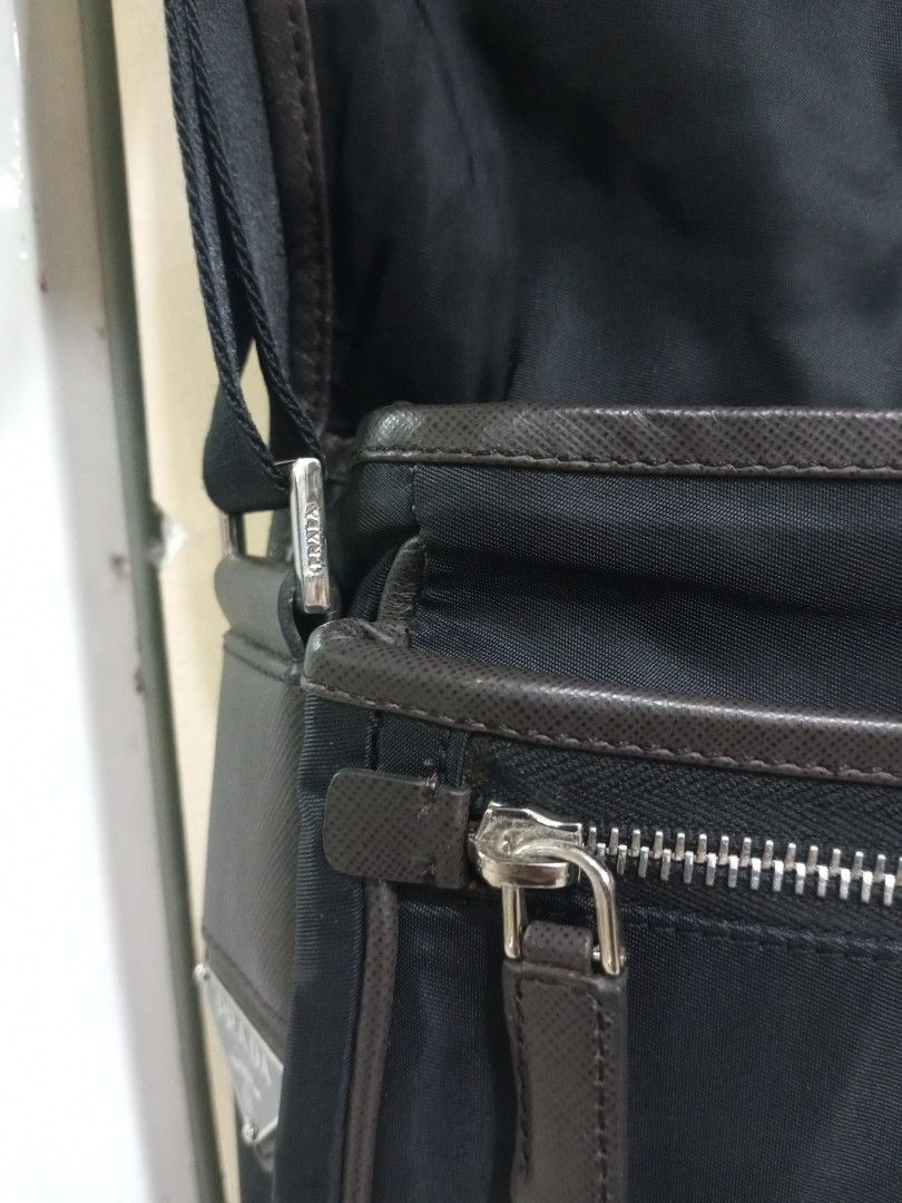Prada Black Nylon Leather Trim Messenger Bag (Category: Luxury Bags & Wallets) located in Bacolod City. Submitted by exequelgra46775 (Listing ID 1454303426, Image 3). Description: - Authentic Prada messenger bag - Color: Black nylon with brown leather trim - Closure: Zip - Features: Adjustable strap, interior zip pocket - Iconic Prada logo on the front - Made in Italy - Ideal for everyday use - Issue Missing white tag and made in Italy .