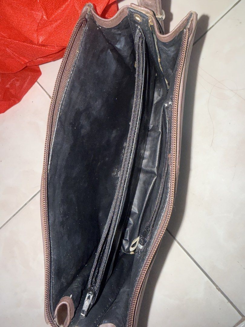 Prada Milano Brown Shoulder Bag NEEDS CLEAN ONLY (Category: Luxury Bags & Wallets) located in Tanauan. Submitted by swifttiger.c7f149 (Listing ID 1454355465, Image 2). Description: - Brown Prada shoulder bag - Main compartment with interior zip pocket - Exterior in decent condition - Adjustable strap for comfortable wear - Perfect for everyday use.