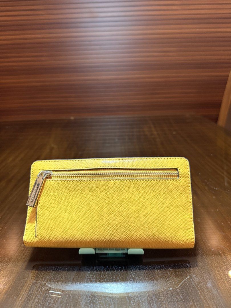 Preloved (Category: Wallets & Card holders) located in Cabanatuan. Submitted by closet-loop (Listing ID 1454200370, Image 3). Description: K@te Spade Maddison Slim Bifold wallet ✔️ Used (Mint condition) Php 2,500 Saffiano Leather Color: yellow.