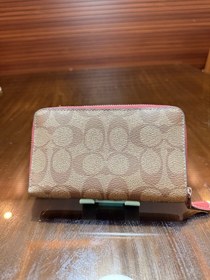 Preloved for sale (Category: Wallets & Card holders) located in Cabanatuan. Submitted by closet-loop (Listing ID 1454201312, Image 2). Description: C0ach Medium Strawberry Zipped around wallet ✔️ Used (Mint condition) Php 2,000 Color: Khaki/Electric Red.