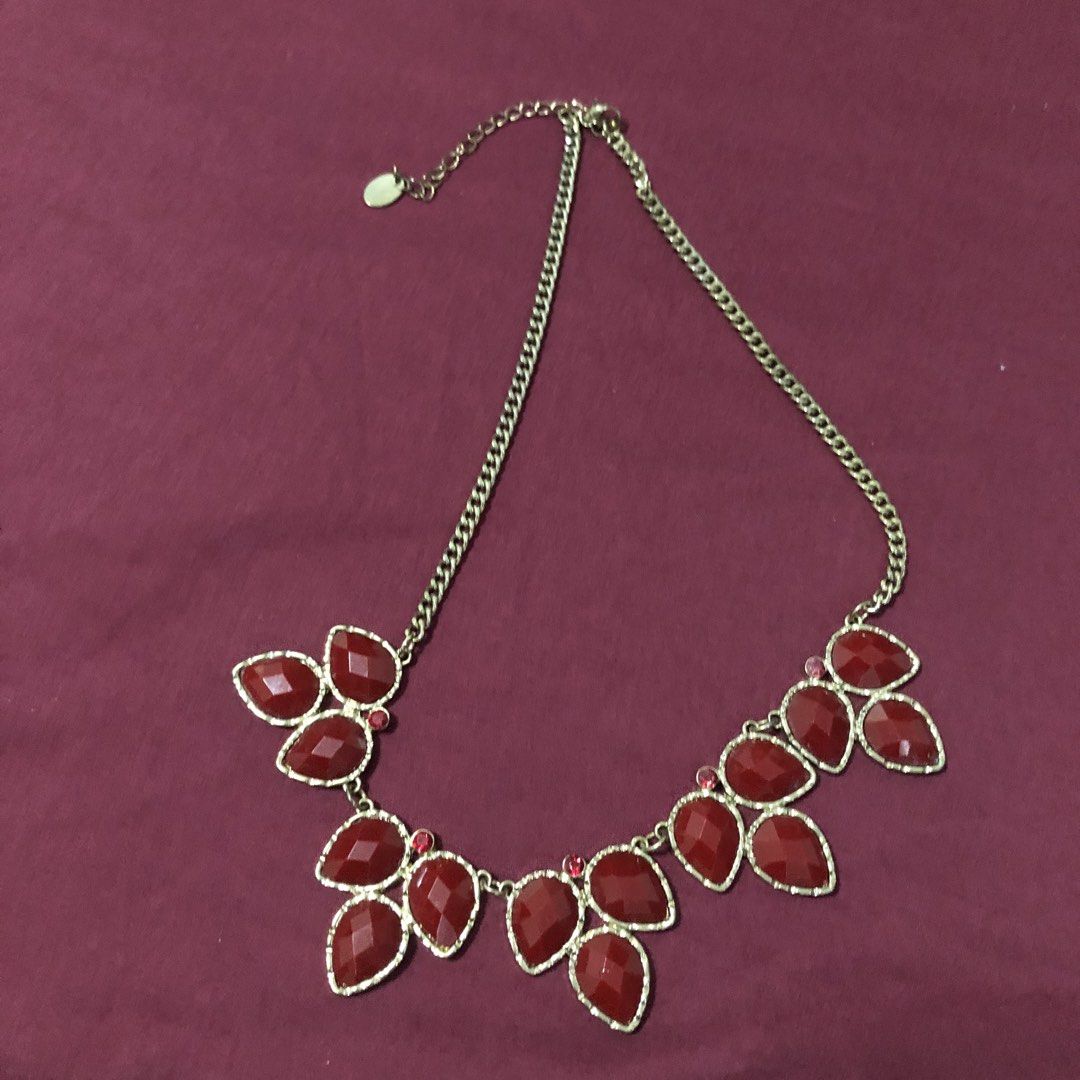 Red Gemstone Statement Necklace (Category: Necklaces) located in Davao. Submitted by giftopia (Listing ID 1454228238, Image 2). Description: Gold-tone chain necklace with a cluster of red teardrop gemstones and small red accents. Adds a pop of color, perfect for any occasion..