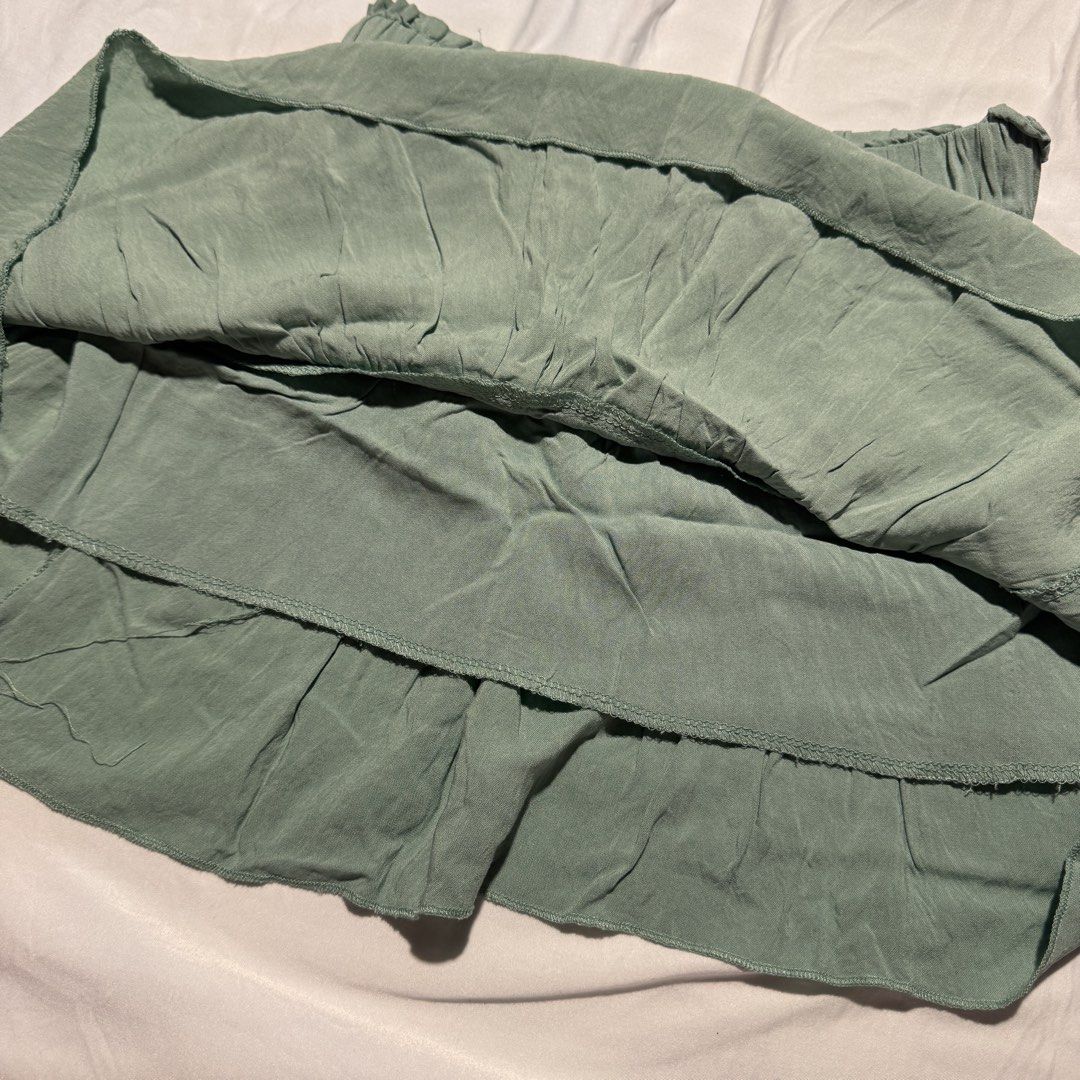Sage Green Tiered Ruffle Mini Skirt (Category: Skirts) located in Rizal. Submitted by zlaaa_ (Listing ID 1454209083, Image 3). Description: - Sage green mini skirt - Comfortable elasticated waistband - Two tiers with charming ruffle details - Lightweight fabric, perfect for warm weather - Effortlessly style with tees or dressy tops 📍Loc: Rod. Rizal 🚚 MOD: J&T, Lalamove (buyer shoulders shipping) 💳 MOP: Gcash, Maribank, or Bank Transfer ❗️Payme