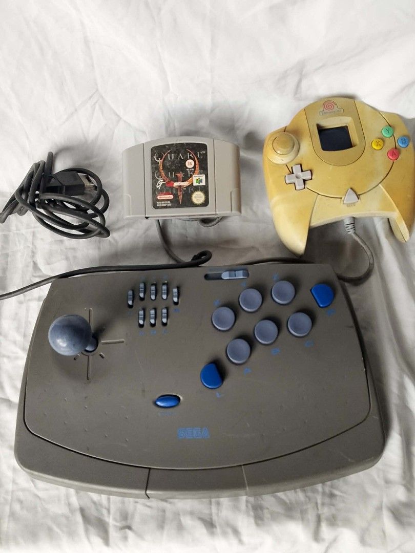 Sega Dreamcast Controller, N64 Game, Arcade Stick (Category: Others) located in Quezon City. Submitted by jpnvintageonline (Listing ID 1454324850, Image 1). Description: - Sega Dreamcast Controller (Yellowed) - Arcade Stick with Joystick and Multiple Buttons - Nintendo 64 Game: Quake 64 - Bundle Deal for Retro Gamers!.