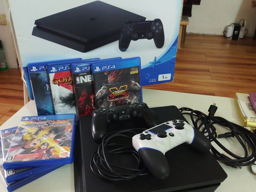 Sony PlayStation 4 1TB Console with Games and Controllers (Category: PlayStation) located in Manila. Submitted by crizzy.1101 (Listing ID 1454197100, Image 3). Description: - Sony PlayStation 4 (PS4) Console - 1TB Storage Capacity - Two Controllers (1 Black, 1 White) - Included Games: God of War, NBA 2K16 Street Fighter V Arcade Edition, Naruto to Boruto: Shinobi Striker - All Necessary Cables Included - Ready for immediate gaming!.