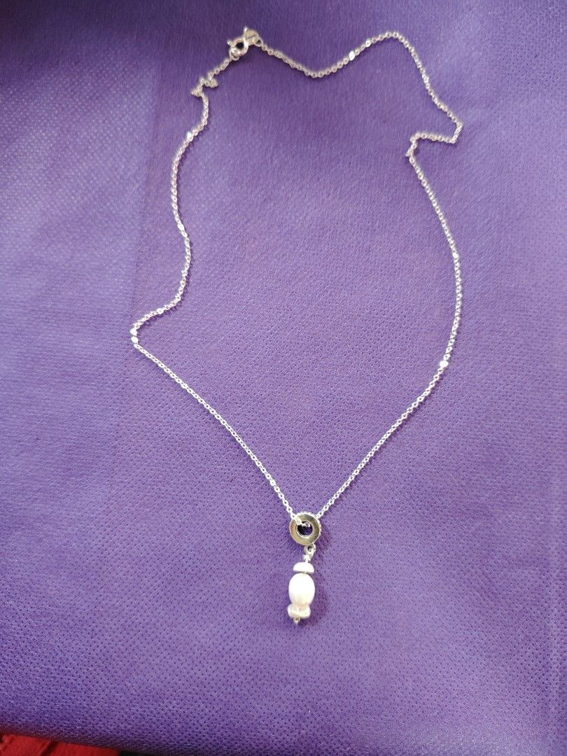 Sterling Silver Necklace with Pearl Pendant (Category: Necklaces) located in Baguio. Submitted by ezelmix94436 (Listing ID 1454364482, Image 1). Description: - Genuine sterling silver chain necklace - Stamped '925' and 'ITALY' on the clasp - Features a circular pendant with a dark stone - Adorned with a unique, irregular shaped dangling pearl - Simple, classic, and elegant design.