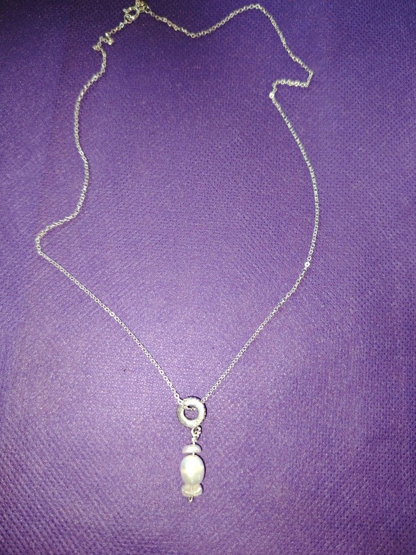 Sterling Silver Necklace with Pearl Pendant (Category: Necklaces) located in Baguio. Submitted by ezelmix94436 (Listing ID 1454364482, Image 2). Description: - Genuine sterling silver chain necklace - Stamped '925' and 'ITALY' on the clasp - Features a circular pendant with a dark stone - Adorned with a unique, irregular shaped dangling pearl - Simple, classic, and elegant design.