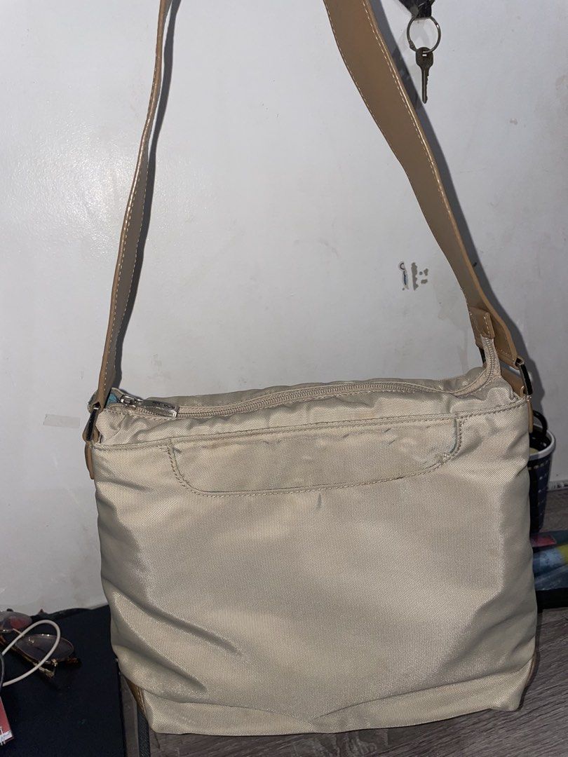 Tumi Khaki Nylon Crossbody Bag (Category: Luxury Bags & Wallets) located in Cavite. Submitted by thelma9.27 (Listing ID 1454298545, Image 2). Description: - Brand: Tumi - Color: Khaki - Material: Durable Nylon - Features: Main zippered compartment, front pocket - Ideal for: Everyday use - Condition: Like new may konting stain lang sa loob. But overall maganda siya.