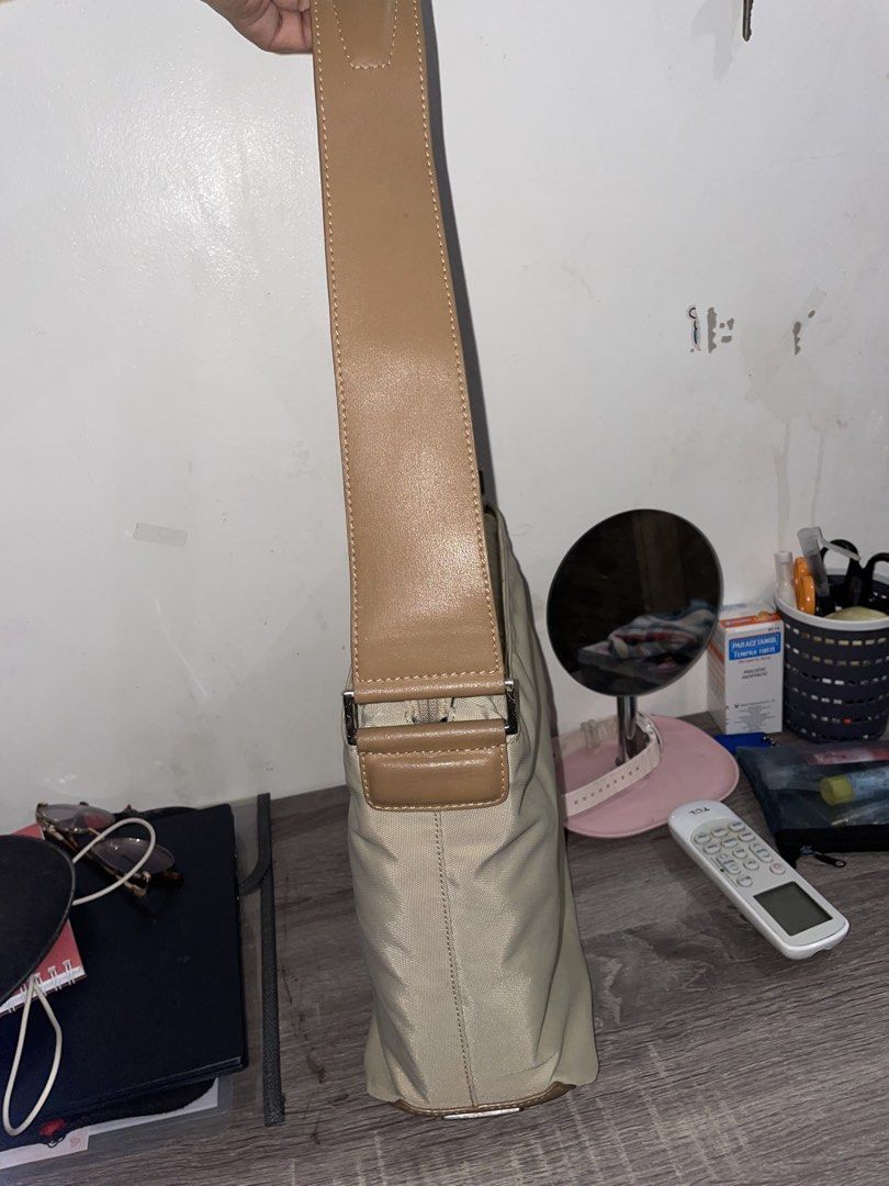 Tumi Khaki Nylon Crossbody Bag (Category: Luxury Bags & Wallets) located in Cavite. Submitted by thelma9.27 (Listing ID 1454298545, Image 3). Description: - Brand: Tumi - Color: Khaki - Material: Durable Nylon - Features: Main zippered compartment, front pocket - Ideal for: Everyday use - Condition: Like new may konting stain lang sa loob. But overall maganda siya.