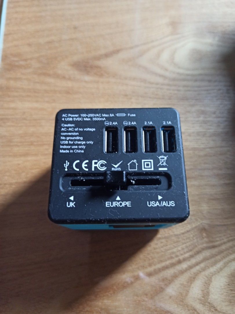 Universal World Travel Plug featuring four USB ports and a multiple AC socket (Category: Electrical, Adaptors & Sockets) located in Caloocan City. Submitted by rtarellano (Listing ID 1454227955, Image 1). Description: - Universal World Travel Plug - Features 4 USB ports (2.1A, 2.1A, 2.4A, 2.4A) - Includes 1 universal AC socket - Compatible with USA/AUS, Europe, and UK outlets - Compact and portable design - Ideal for international travel.