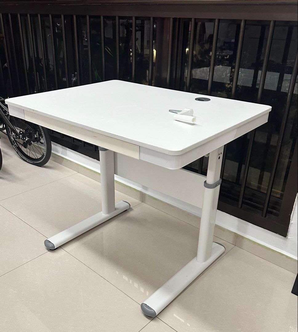 White computer table (Category: Tables & Sets) located in Singapore. Submitted by kaydenong22 (Listing ID 1454342566, Image 2). Description: 80cm length x 60cm width Used White color manual retractable computer table with drawer. Some scratches on the table top.