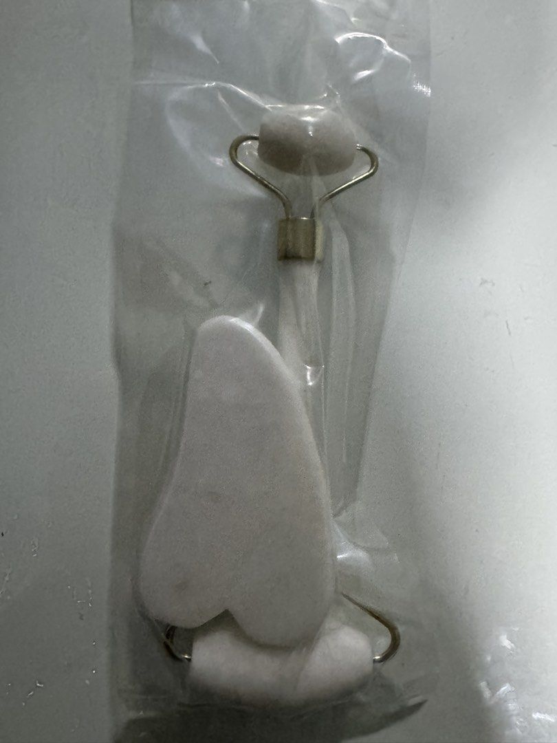 White Jade Roller and Gua Sha Set (Category: Face Care) located in Manila. Submitted by decluterthings888 (Listing ID 1454295547, Image 1). Description: - Complete skincare set: Includes a white jade roller and a white gua sha tool. - Jade Roller: Features a smaller stone for precise areas and a larger stone for broader application. - Gua Sha Tool: Beautifully crafted in a heart shape for effective facial massage. - Material: Made from natural wh