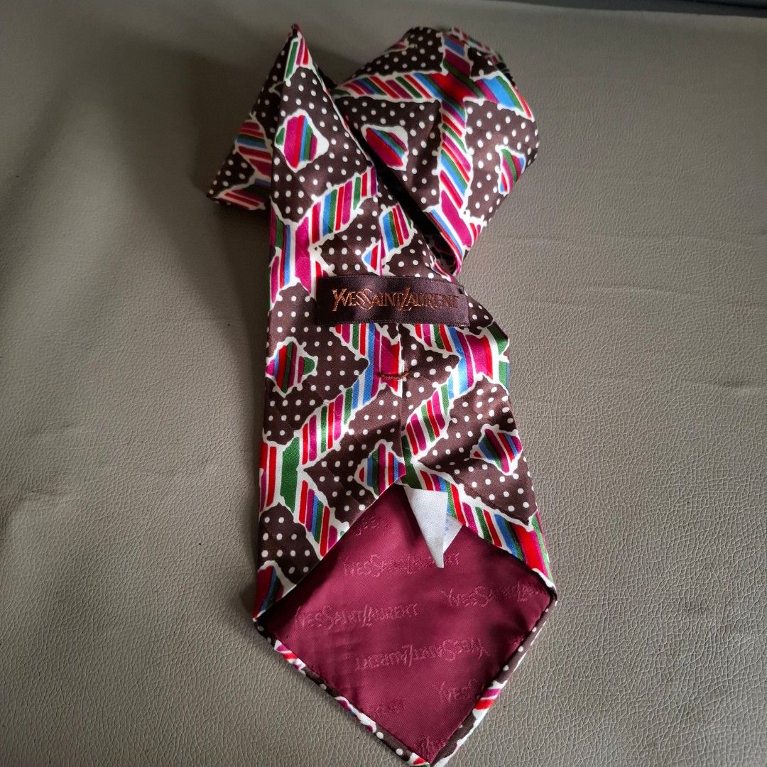 Yves Saint Laurent YSL Silk Tie (Category: Ties) located in Don Carlos. Submitted by PphiXi_Finds (Listing ID 1454244420, Image 3). Description: - Material: Brown Silk - Pattern: White polka dots and abstract shapes (red, blue, green, pink) - Brand: Yves Saint Laurent (YSL logo embroidered and woven into lining) - Style: Unique accessory for adding flair.