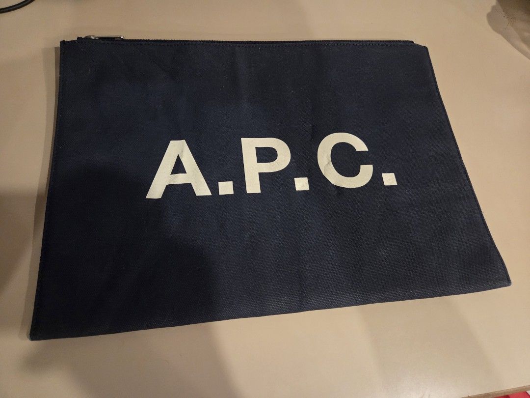 A.P.C. Navy Blue Pouch (Category: Luxury Bags & Wallets) located in Cabuyao City. Submitted by swiftdeer.ed9787 (Listing ID 1454556545, Image 1). Description: FOR SALE AUTHENTIC APC TABLET SLEEVE, POUCH, DOCUMENT PRICE: 2500 FIX LOCATION: CABUYAO LAGUNA - Navy blue pouch - Large white A.P.C. logo - Zipper closure at the top - Ideal for organizing essentials or as a clutch - Simple and classic design.