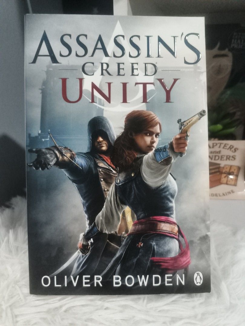 Assassin's Creed Unity by Oliver Bowden (Category: Storybooks) located in Cabuyao City. Submitted by chaptersandwonders143 (Listing ID 1454484693, Image 1). Description: - Assassin's Creed Unity novel by Oliver Bowden - Based on the Ubisoft videogame - Story set during the French Revolution in Paris - Follow Arno and Elise as they seek revenge - A thrilling adventure awaits.