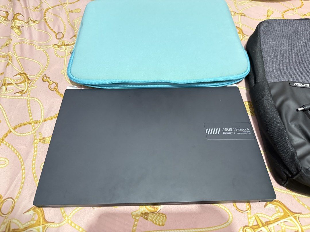 Asus Vivo book 15 OLED (Category: Laptop Bags & Sleeves) located in Caloocan City. Submitted by swiftcloud_7d0725 (Listing ID 1454378812, Image 2). Description: Alightly used, comes with laptop bag,pouch and box and charger..