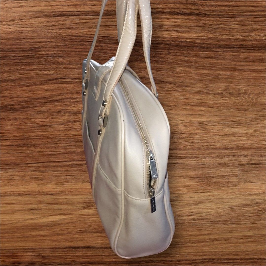 Auth Courreges Bag (Category: Luxury Bags & Wallets) located in Cebu City. Submitted by jc_online_shop (Listing ID 1454416408, Image 3). Description: 15" x 12" x 4" laptop and long folder size can fit bone white color silver tone hardware clean in and out never used- like new condition.