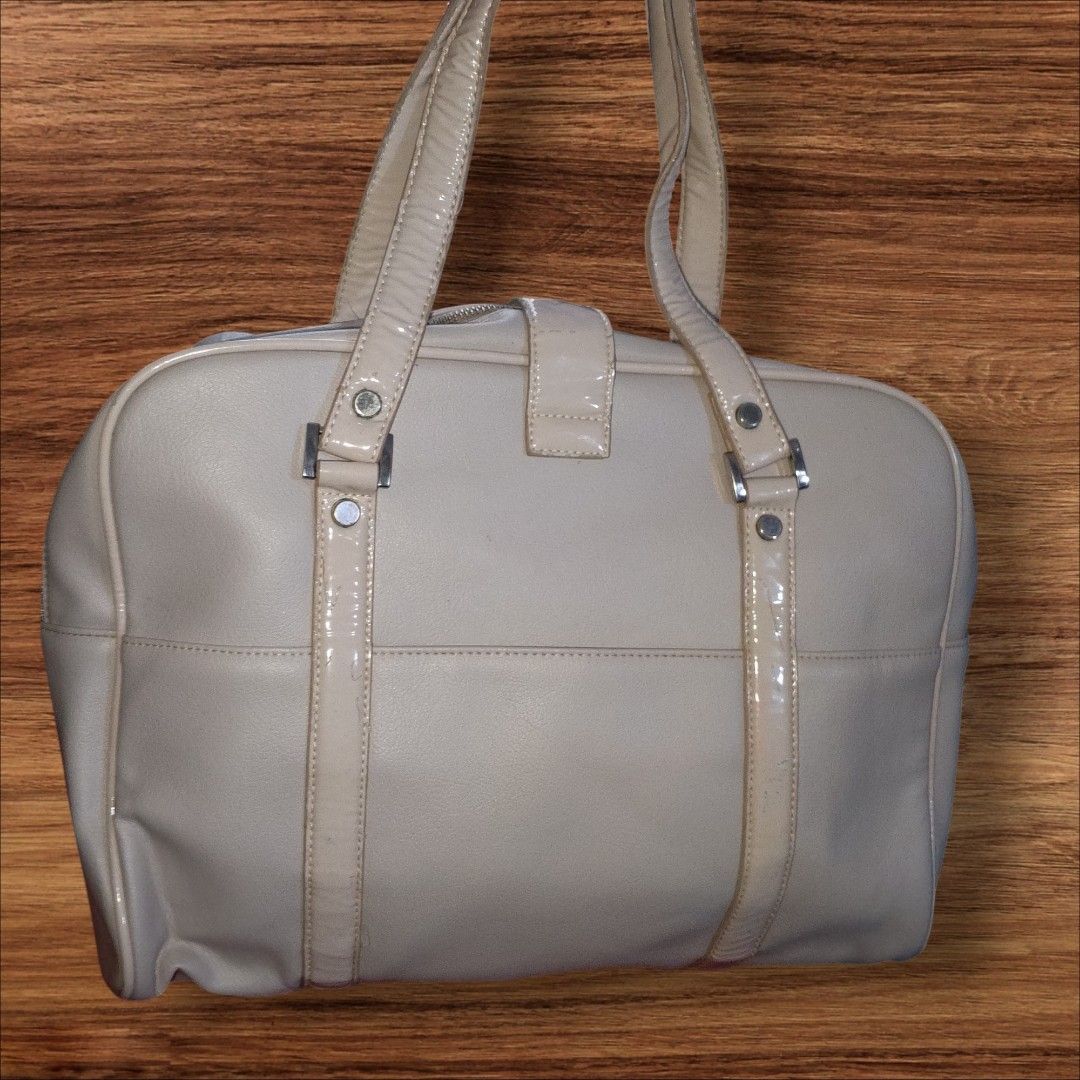 Auth Courreges Bag (Category: Luxury Bags & Wallets) located in Cebu City. Submitted by jc_online_shop (Listing ID 1454416408, Image 2). Description: 15" x 12" x 4" laptop and long folder size can fit bone white color silver tone hardware clean in and out never used- like new condition.